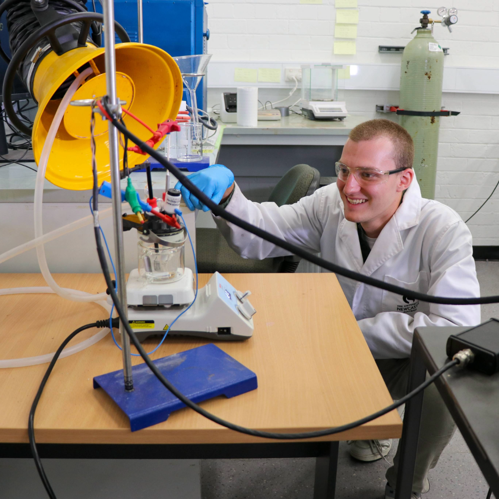 A man using chemistry equipment.