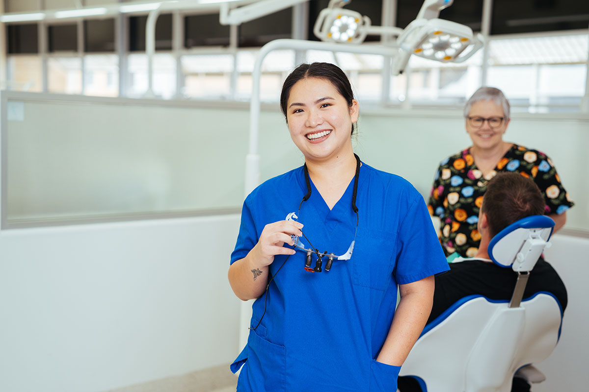 A oral health specialist helping a patient