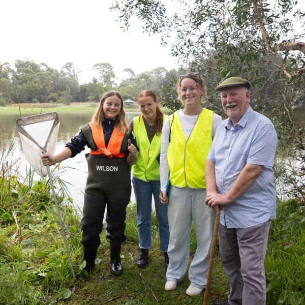 Bequest donor, Michael is pictured with three females amongst wetlands, with a dam pictured in the background. . A Gift of Hope for a Better Future.