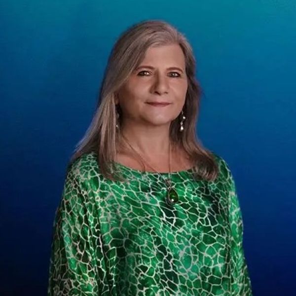 Woman with long hair smiling at the camera. Research highlights gaps in gender-based violence recovery support