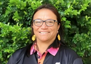 Indigenous woman wearing glasses and smiling for the camera