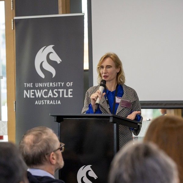 Woman with blonde hair and glasses standing behind a lectern addressing an audience while holding a microphone. Hunter Insights Series reveals hidden workforce potential