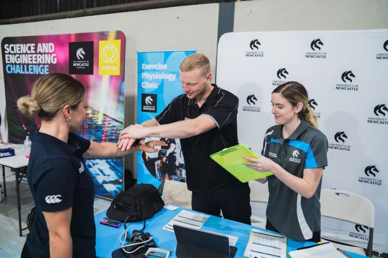 Student conducting check at Exercise Physiology clinic stand
