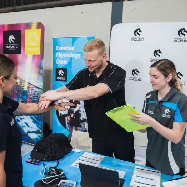 Student conducting check at Exercise Physiology clinic stand