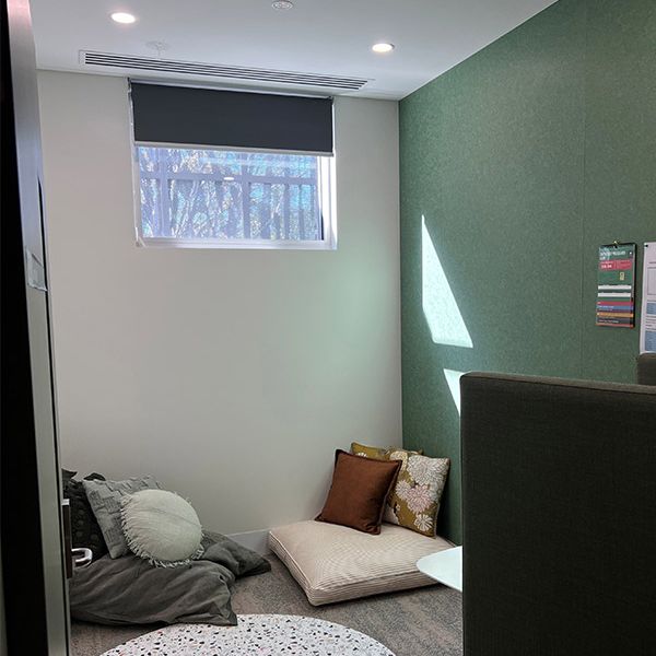 A small room with two bean bags in the corner. A circle white spotted rug is on the ground.