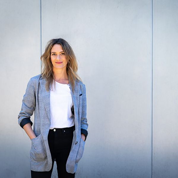 woman standing against wall. Heritage home transformation wins coveted architecture award