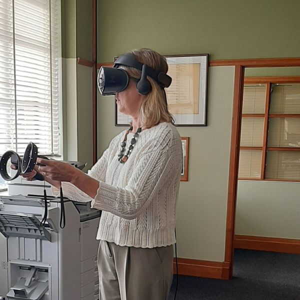 woman with VR headset and hand controls