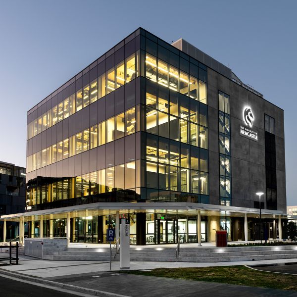 Image shows multi story building lit up at night time. University of Newcastle’s Q Building awarded world-leading 6 Star rating – the first in regional NSW