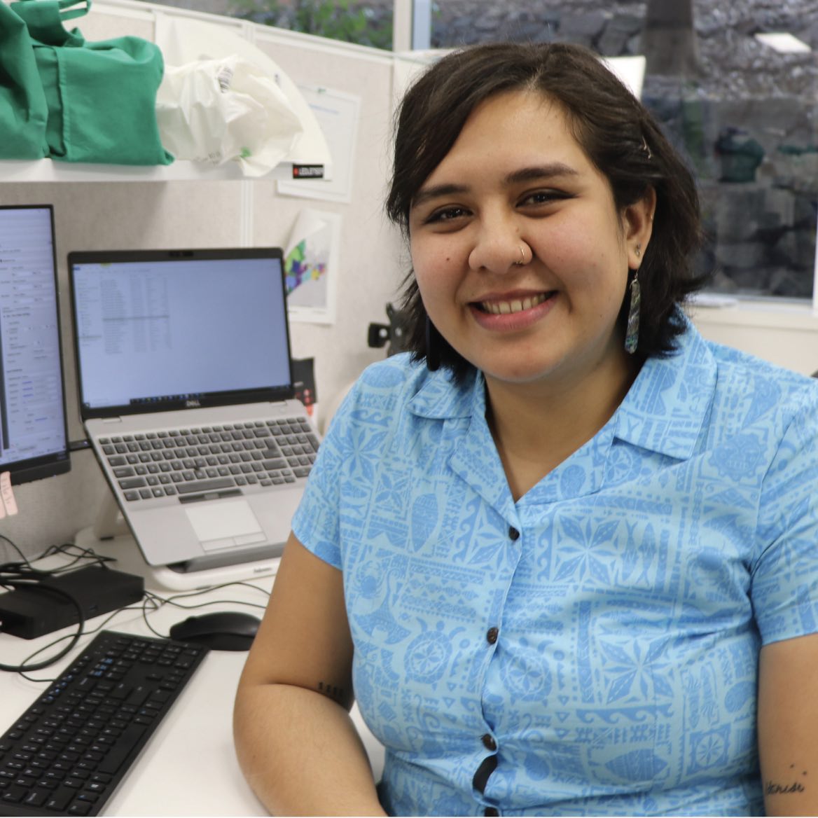 Carrol sitting at a desk smiling at the camera