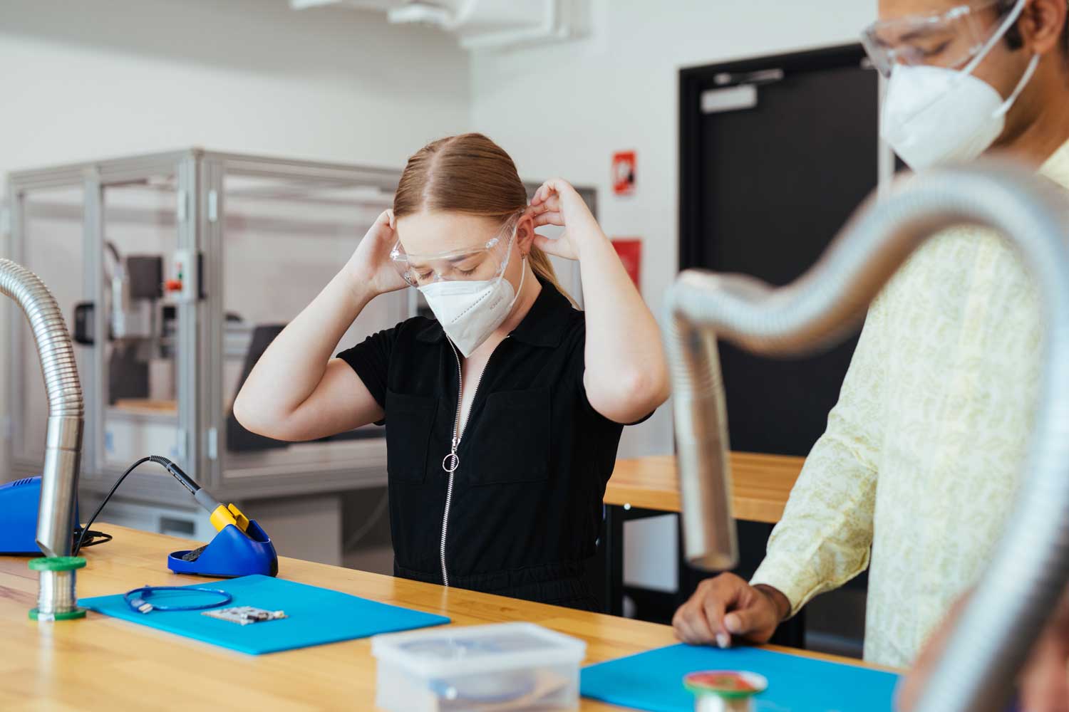 Student putting lab safety gear on.