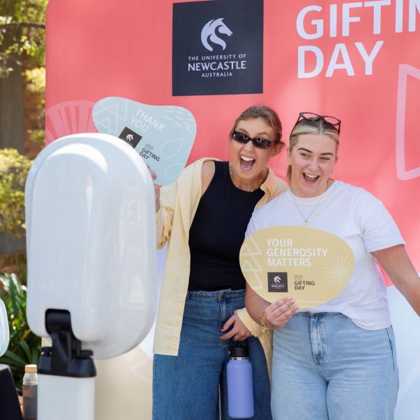 Two women using the photobooth at Gifting Day. 566 people get behind University’s Gifting Day