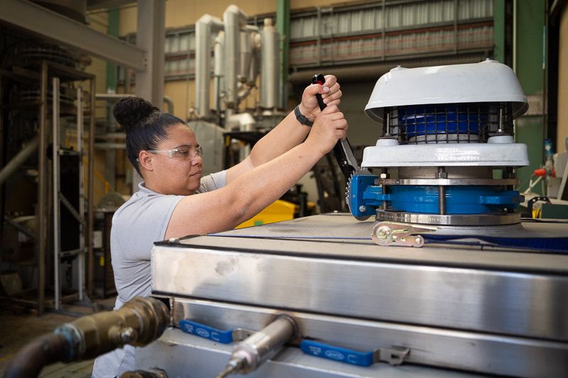 Priscilla is pictured pulling a lever on the Hydro Harvester equipment