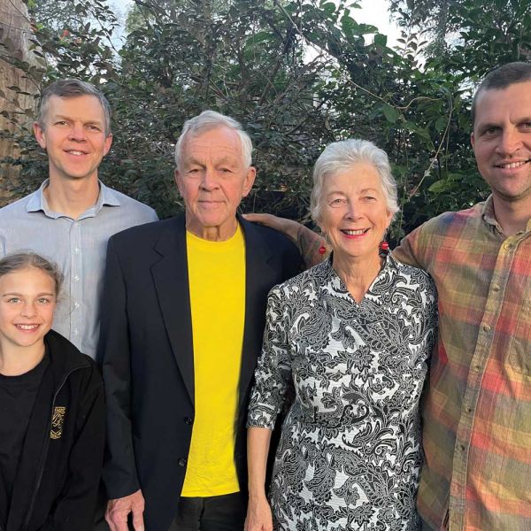 Family group, standing outside, smiling at camera. Why I donate.