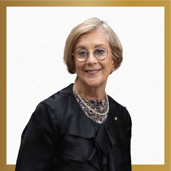 This is a picture of a women wearing a navy blue suit on a white stock background with a gold boarder. 