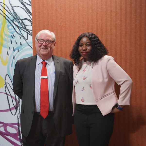 Man and woman smiling for a photo. Building new futures for migrant women