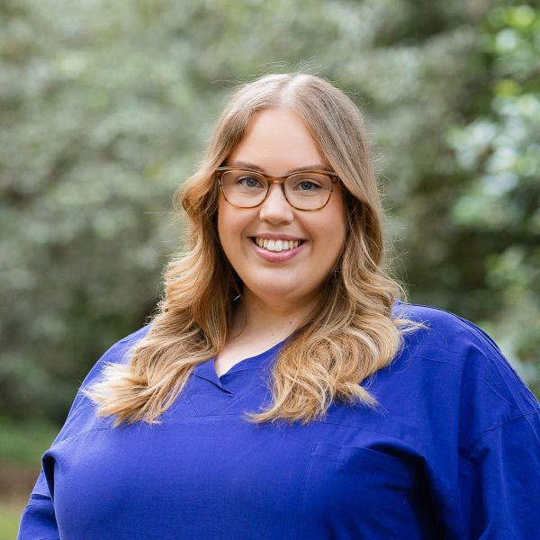 Gamilaroi woman and surgeon, Emily Mason, pictured in blue scrubs.. From the Classroom to the Operating Room: Emily Mason’s Journey as an Indigenous Female Surgeon.