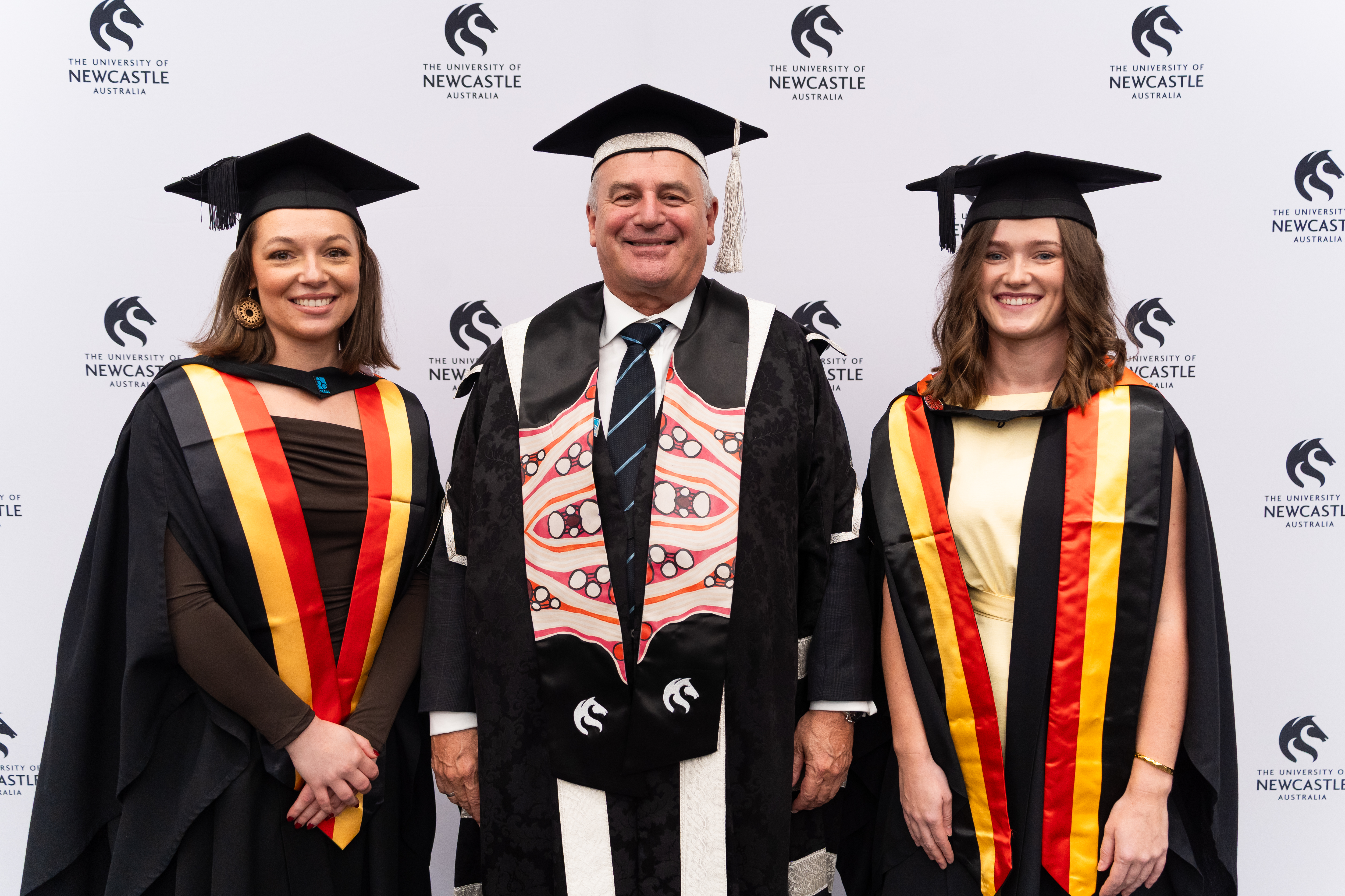 L to R: Bachelor of Nursing graduate Kiah O'Toole, Vice Chancellor Alex Zelinsky, Bachelor of Midwifery graduate Angela Sibley