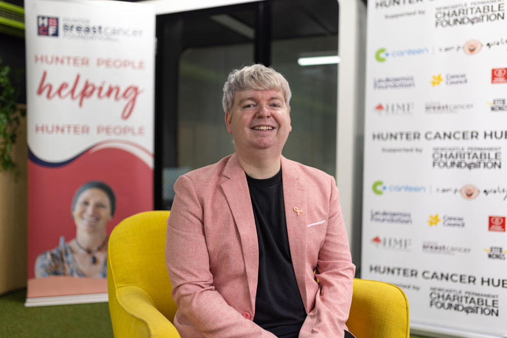 A man sitting at a table smiling