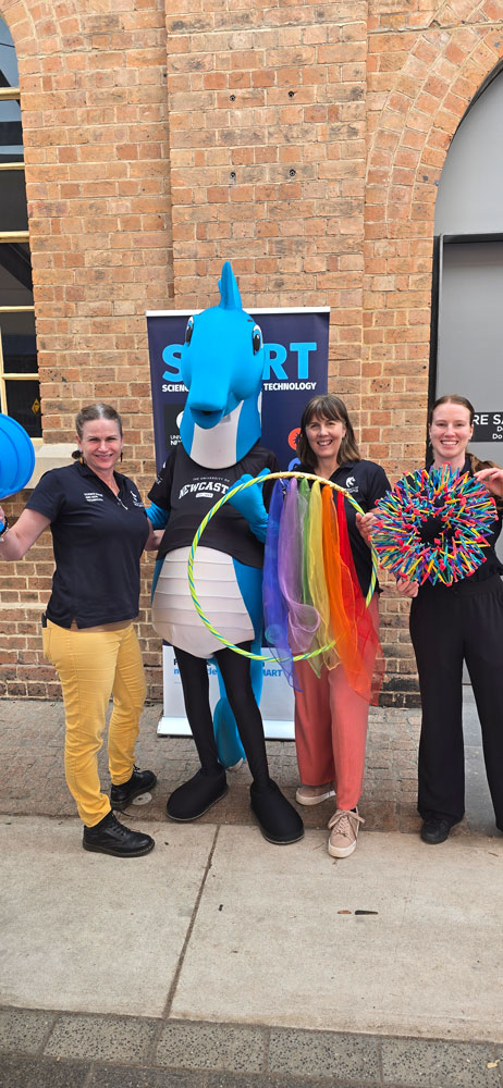 Hunter the mascot with the SMART team posing for a photo