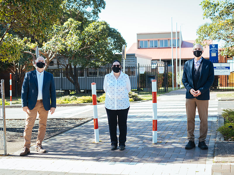 Left to right: Associate Professor Scott Imig, Dr Maura Sellers and Professor John Fischetti stand wearing masks