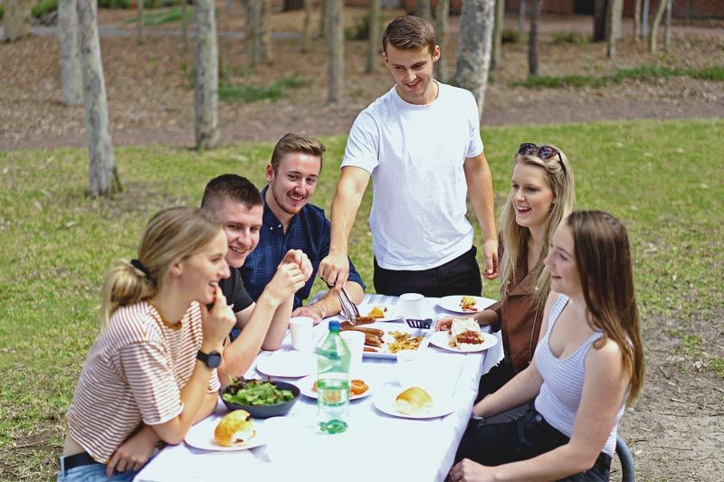 Residents eating on Evatt House outdoor furniture
