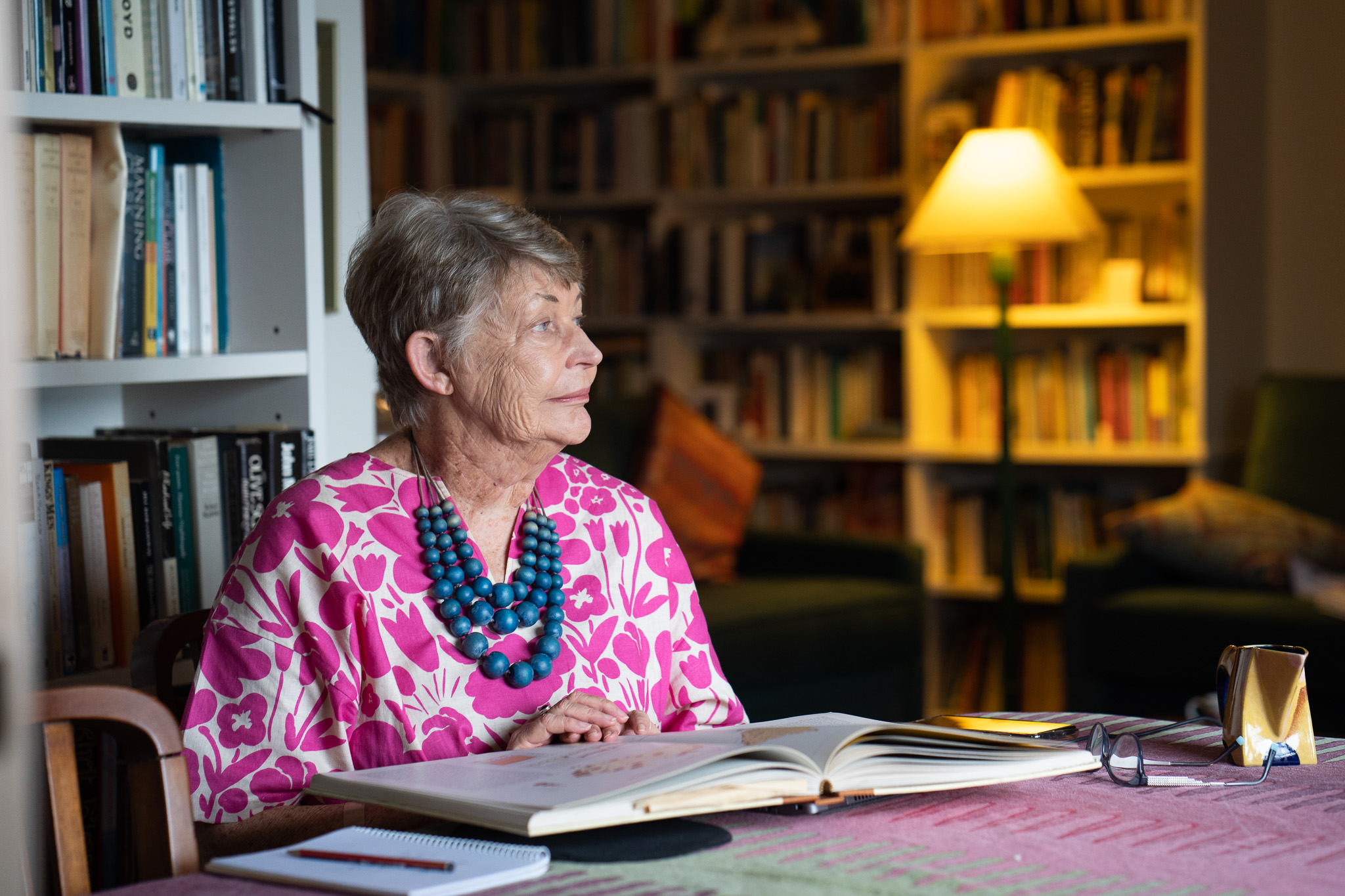 Researcher, Lyndall Ryan, siting in her home studying a book