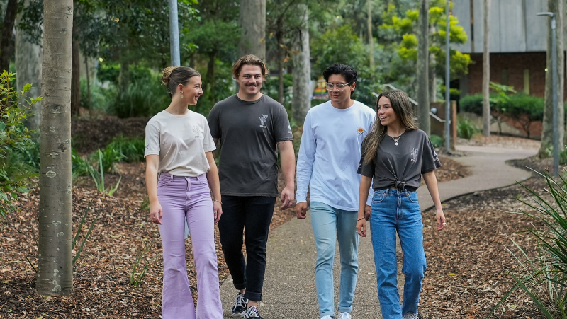 Group of students wearing Borne clothing x University of Newcastle tee's on Callaghan Campus with Dan from the Borne team (pictured in white tee)
