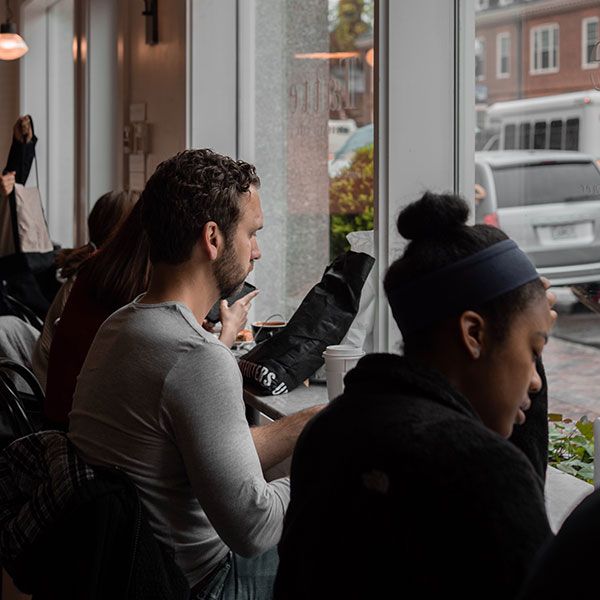 Students studying independently at window