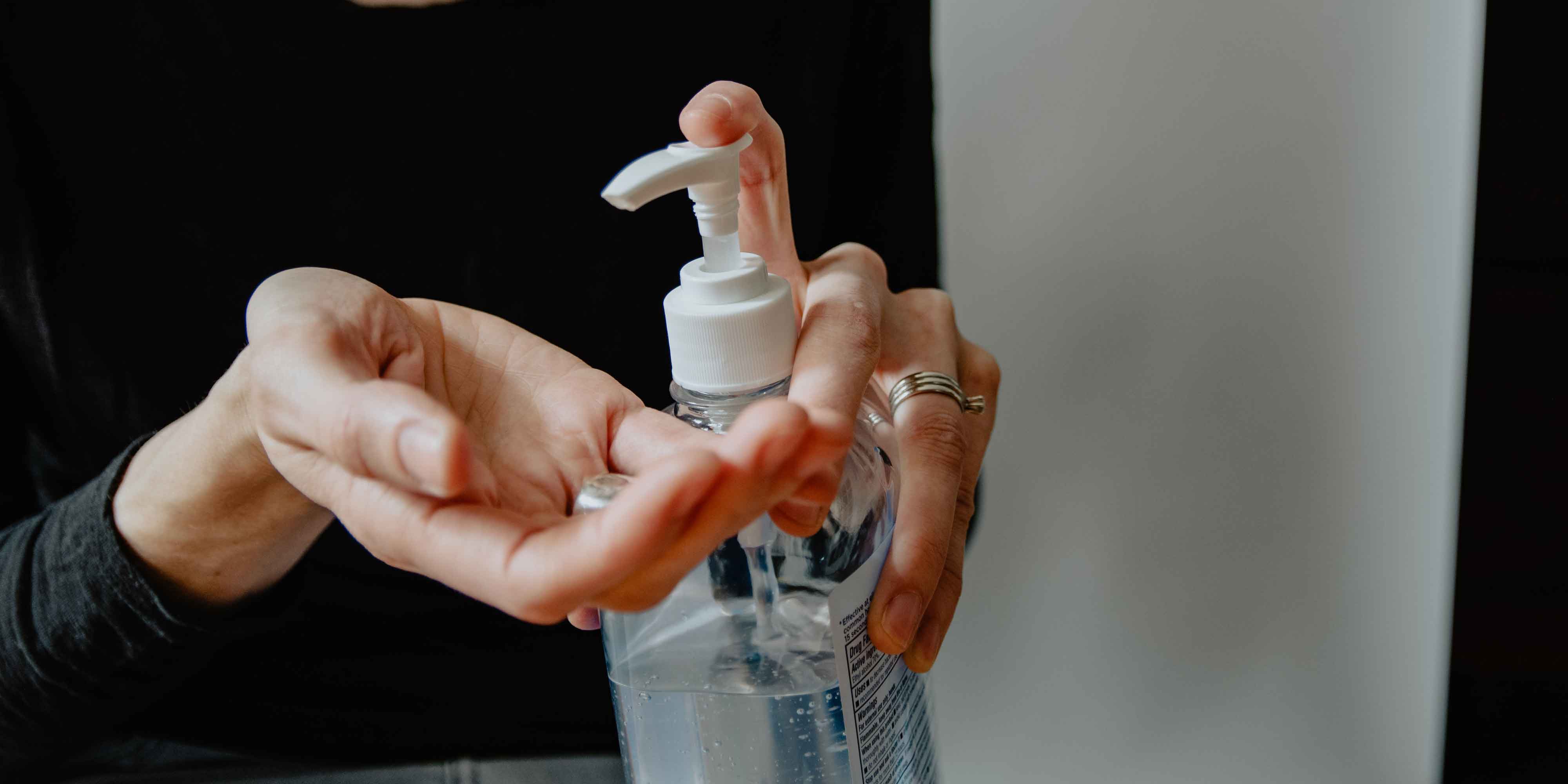 A person pumping hand sanitizer 