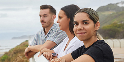 Students smiling on a bridge