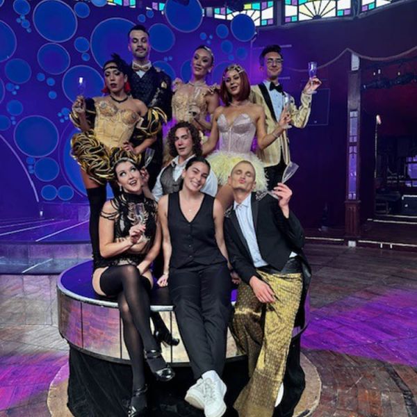 Young woman poses with the cast of circus show Blanc de Blanc in the Spiegeltent