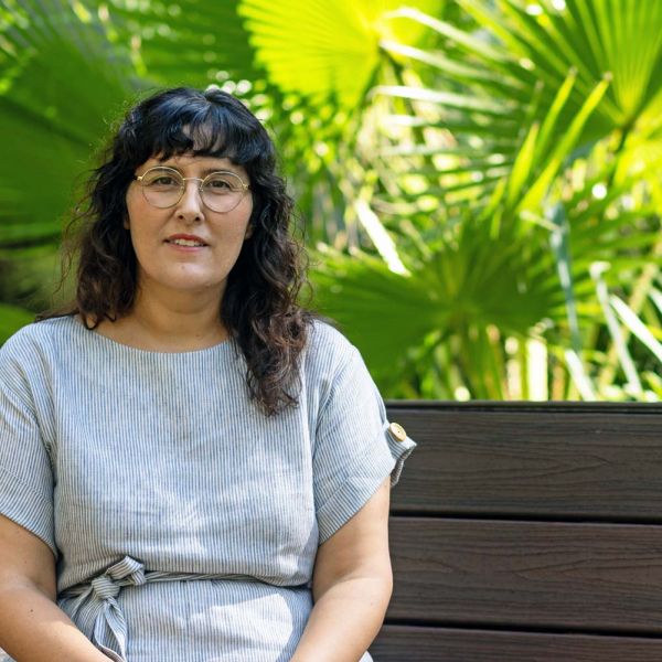 Doctor Effie Karageorgos sitting in greenery at Callaghan campus