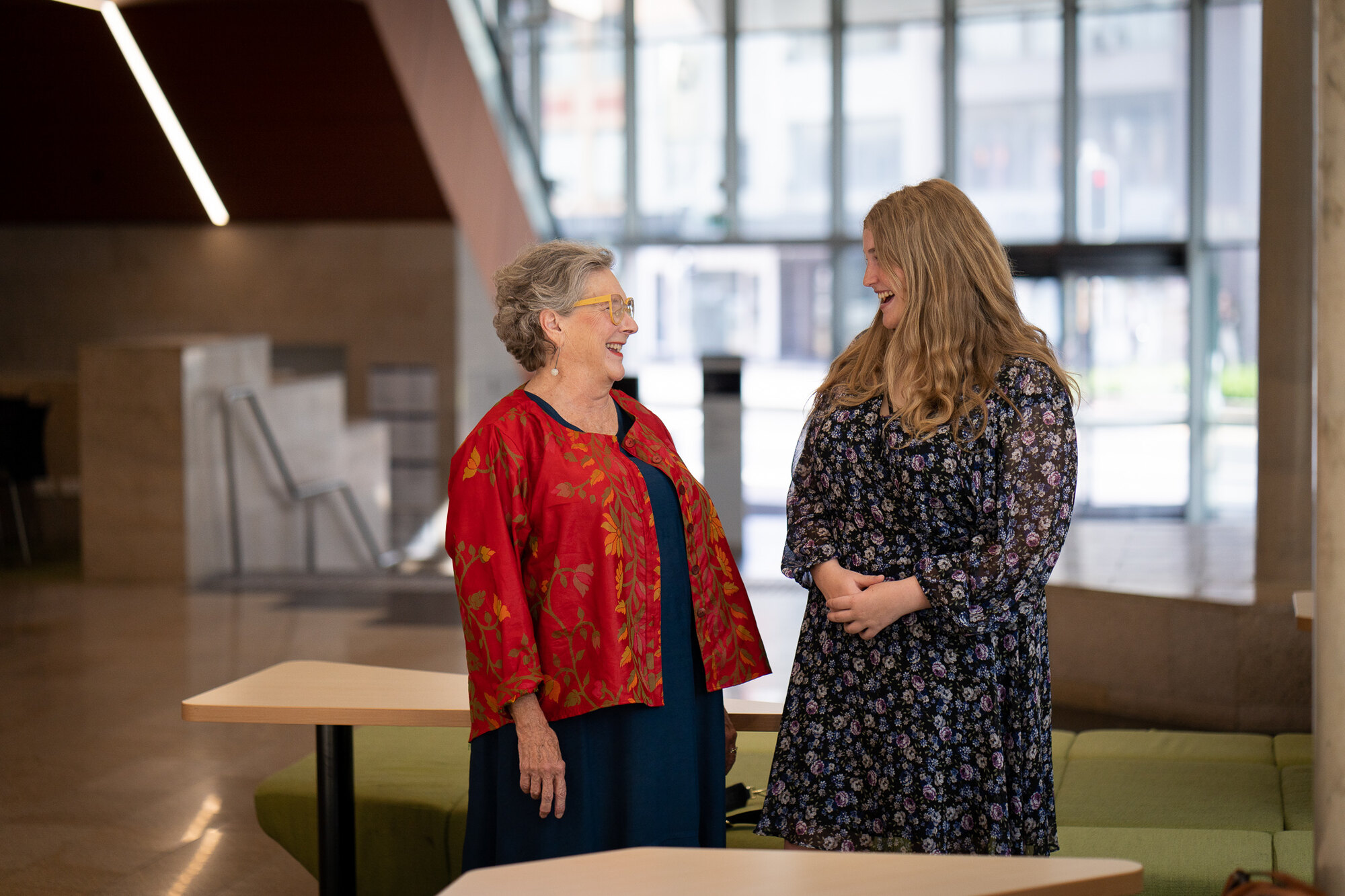 Research Professor Roberta Ryan chatting with a smiling and happy student, Emma Dubos