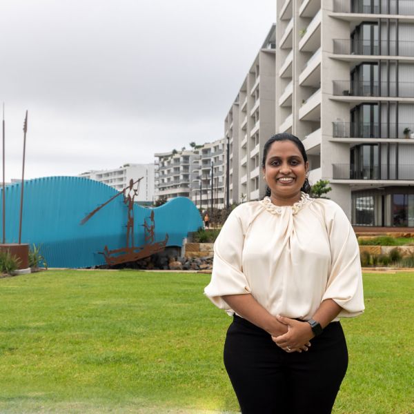 Buddhini Ginigaddara  Dr Buddhini Ginigaddara standing in front of newly constructed buildings at Honeysuckle