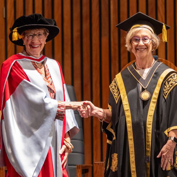 Chancellor Forsythe shakes hands with Her Excellency the Honourable Margaret Beazley AC KC. University community to officially welcome Chancellor Forsythe  