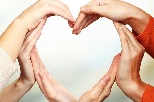 Benefits-carers Peoples hands together making a heart shape