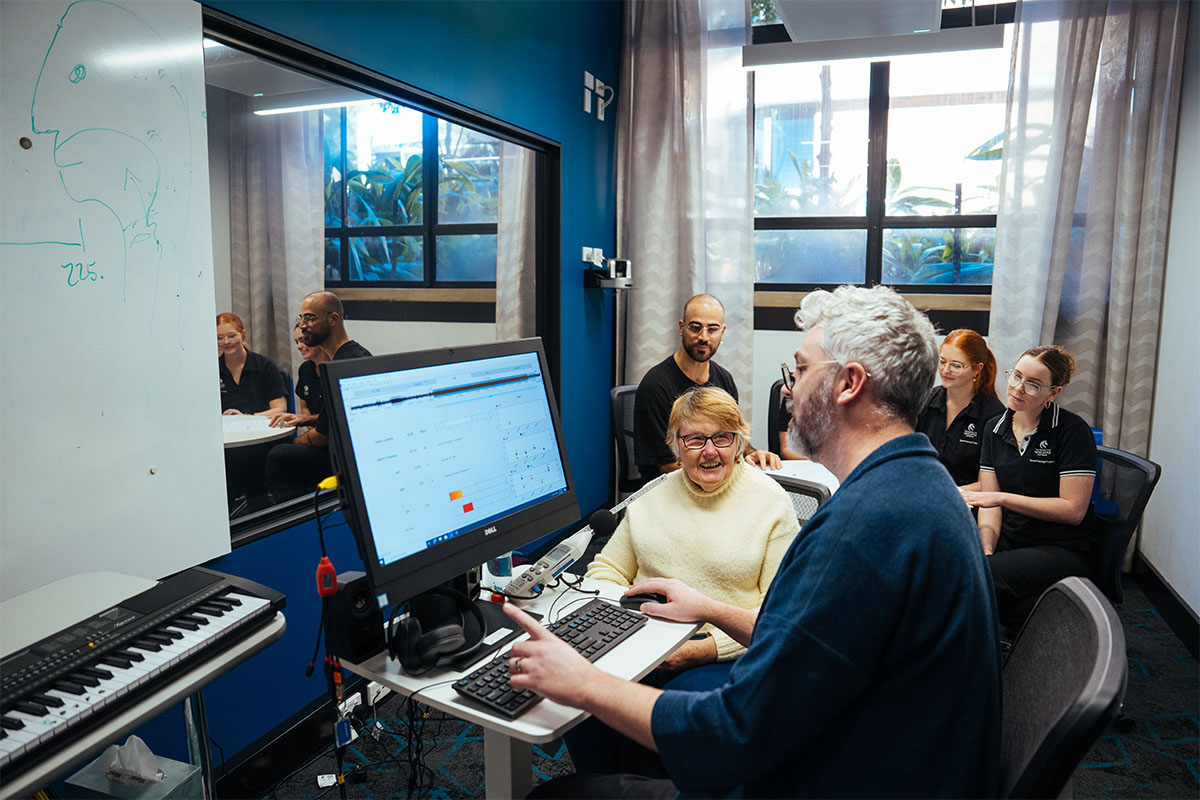 A man sitting at a computer with patients