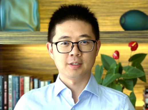 Man wearing glasses and a business short looking at the camera