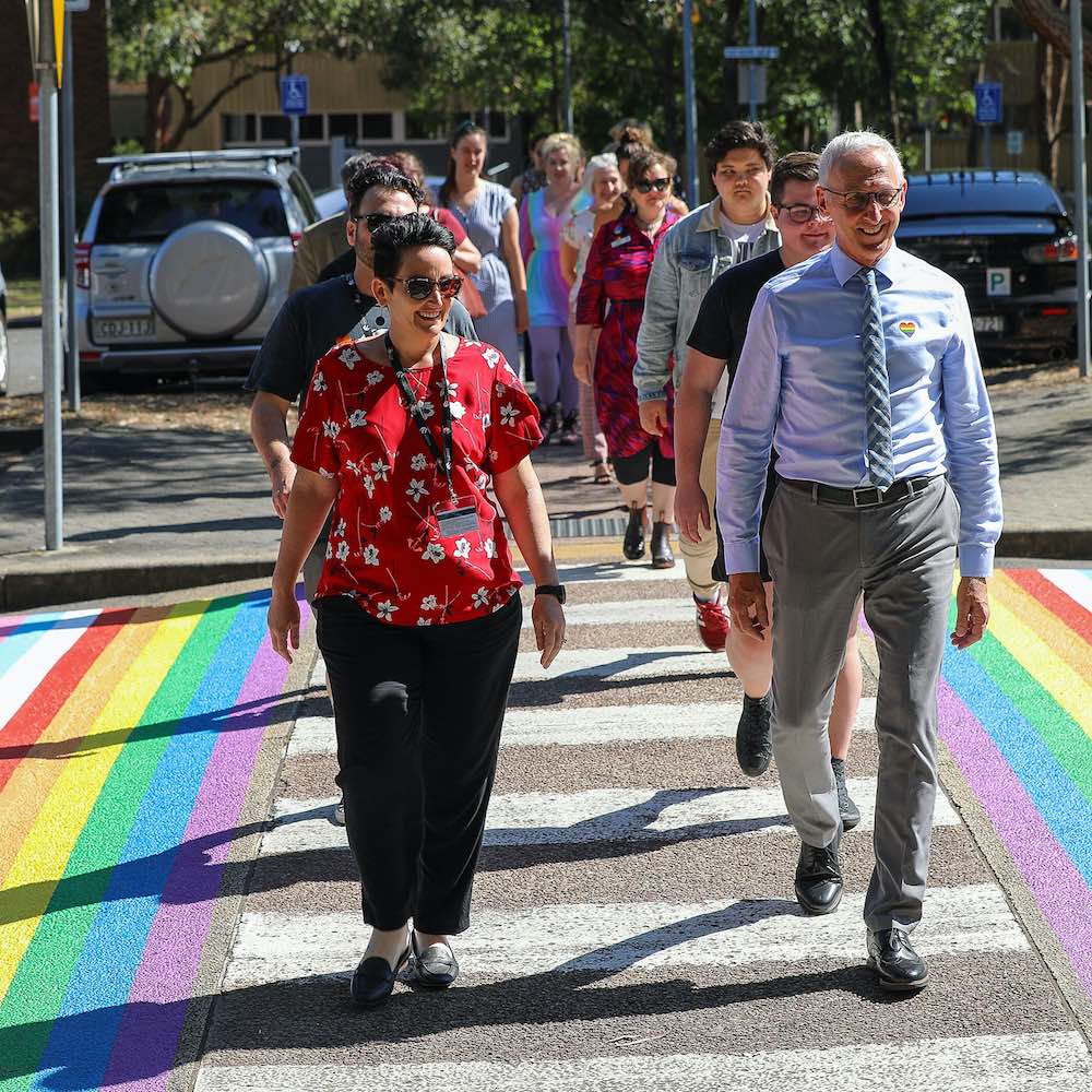 Senior Deputy Vice Chancellor & Vice-President Global Engagement & Partnerships Professor Kevin Hall and Staff Representative Kate McKenny lead the first group to walk the rainbow crossing