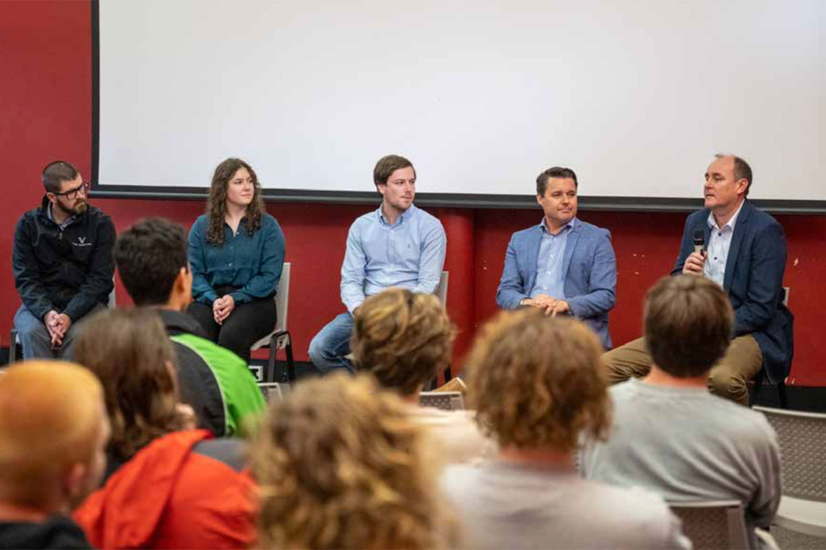 A group of people talking at a seminar