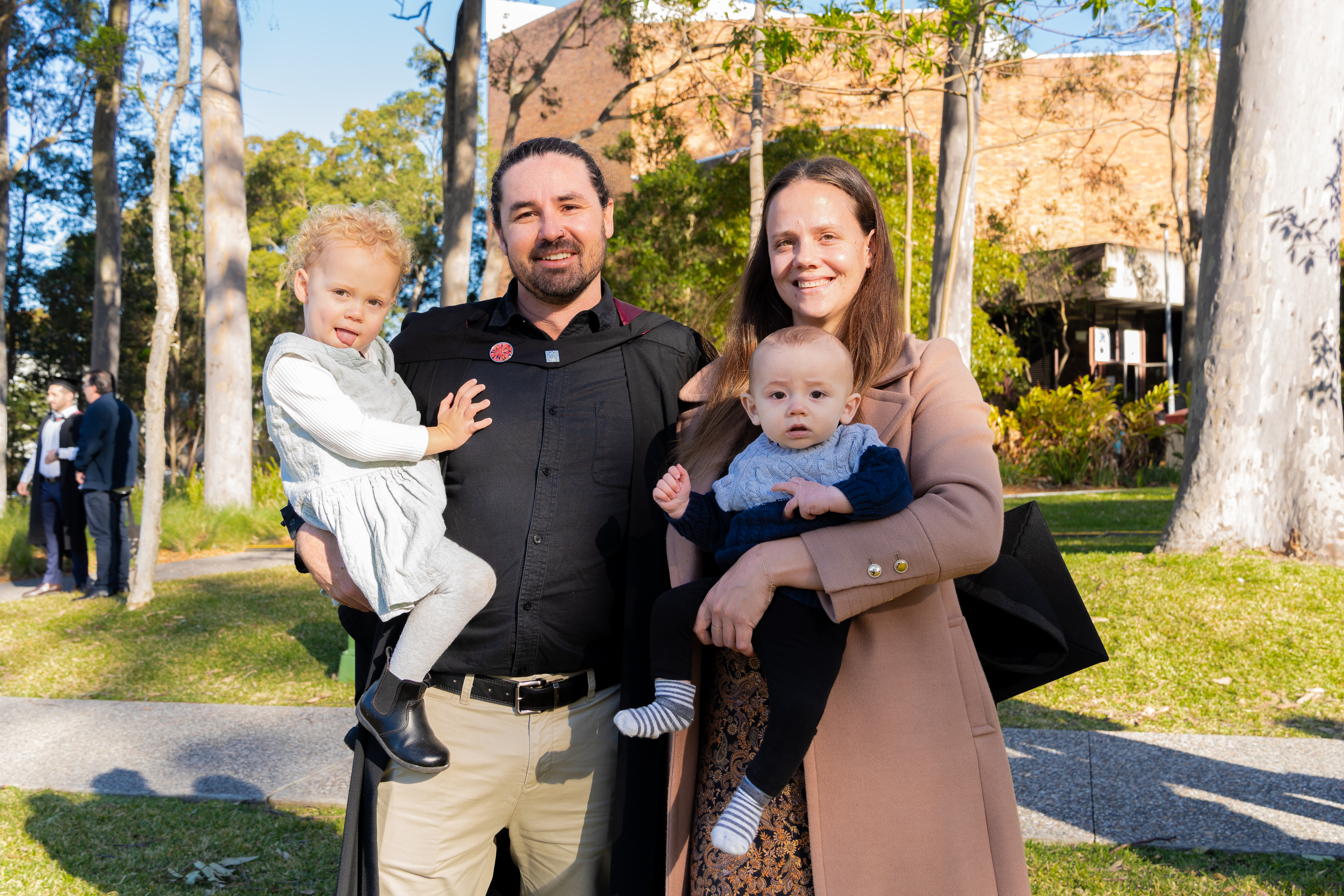 Brendan in his graduation gown with his family