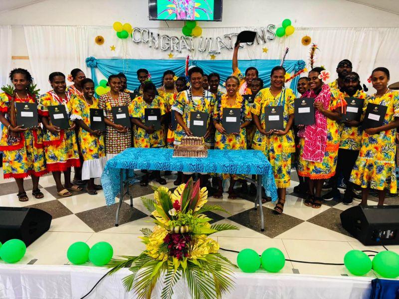 Students holding certificates, celebrating their graduation