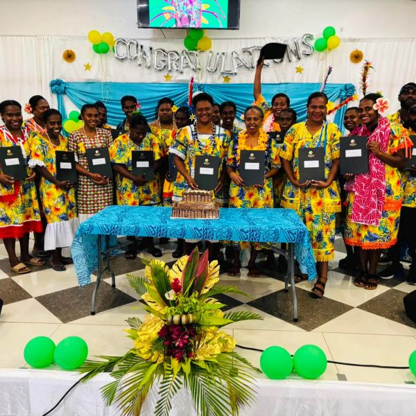 Students holding certificates, celebrating their graduation