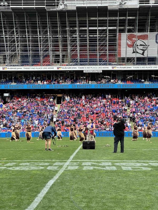 Maddie Lilley and Midnight Dreaming dancers performing on field at McDonald Jones Stadium