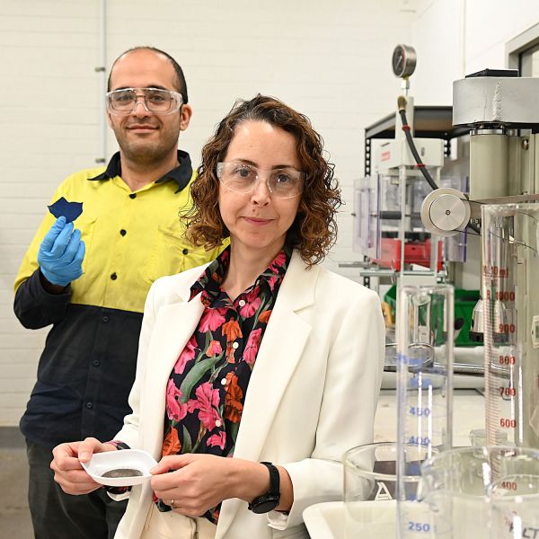 Associate Professor Mahshid Firouzi and PhD candidate Hamidreza Saffarian standing in a lab holding silver material