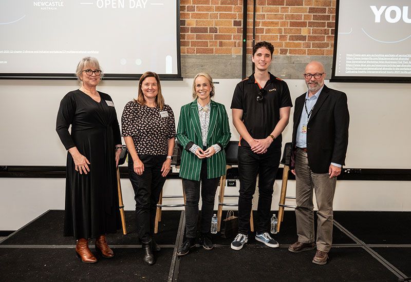 Five people standing on stand