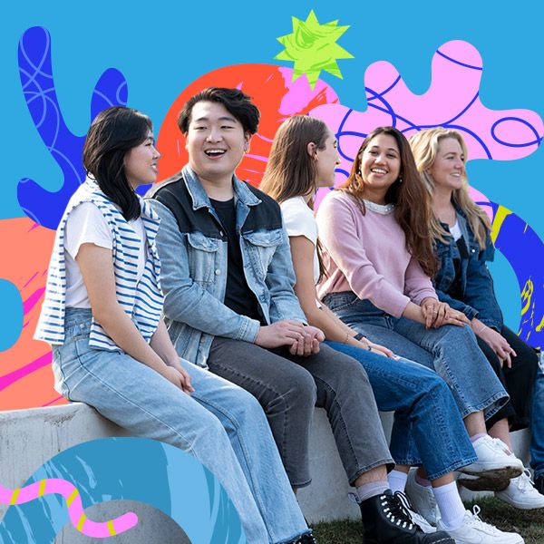 A group of international students sit smiling together