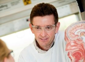 Brainstorming the brain Paul Tooney speaking to a colleague