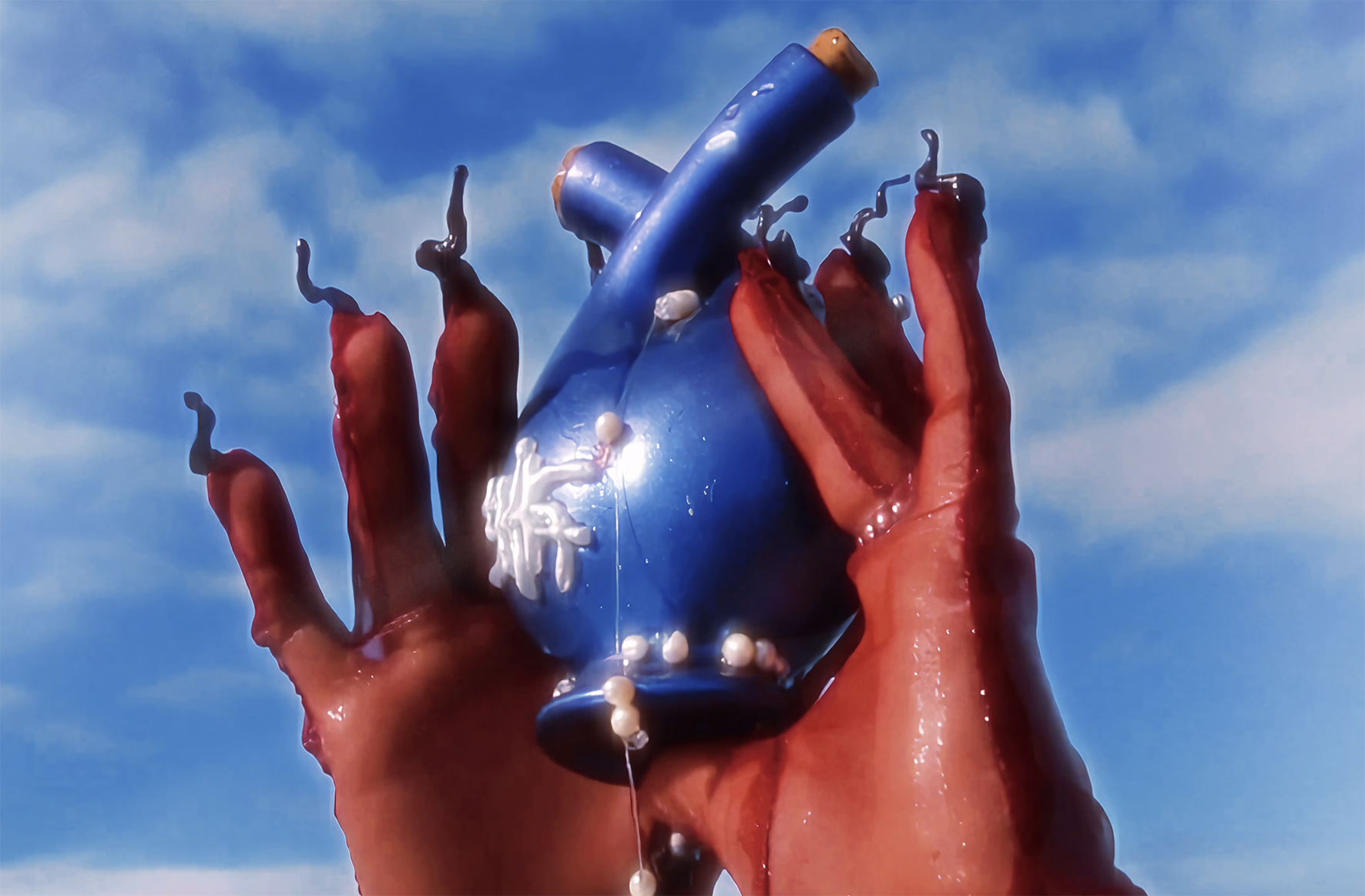 Video still of hands holding an ampulla