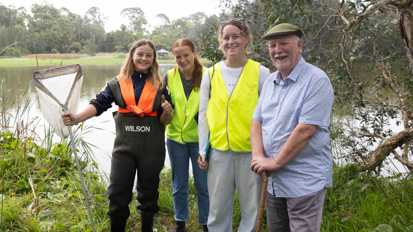 Bequest donor, Michael is pictured with three females amongst wetlands, with a dam pictured in the background. 